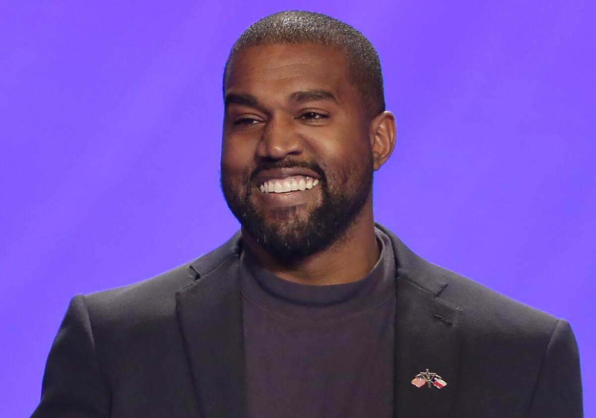 Kanye West wearing a black coat