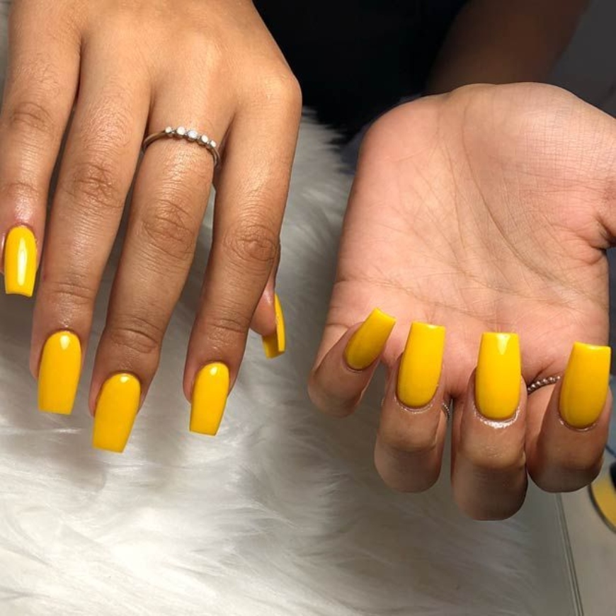 A woman showing her Sunny Yellow nails