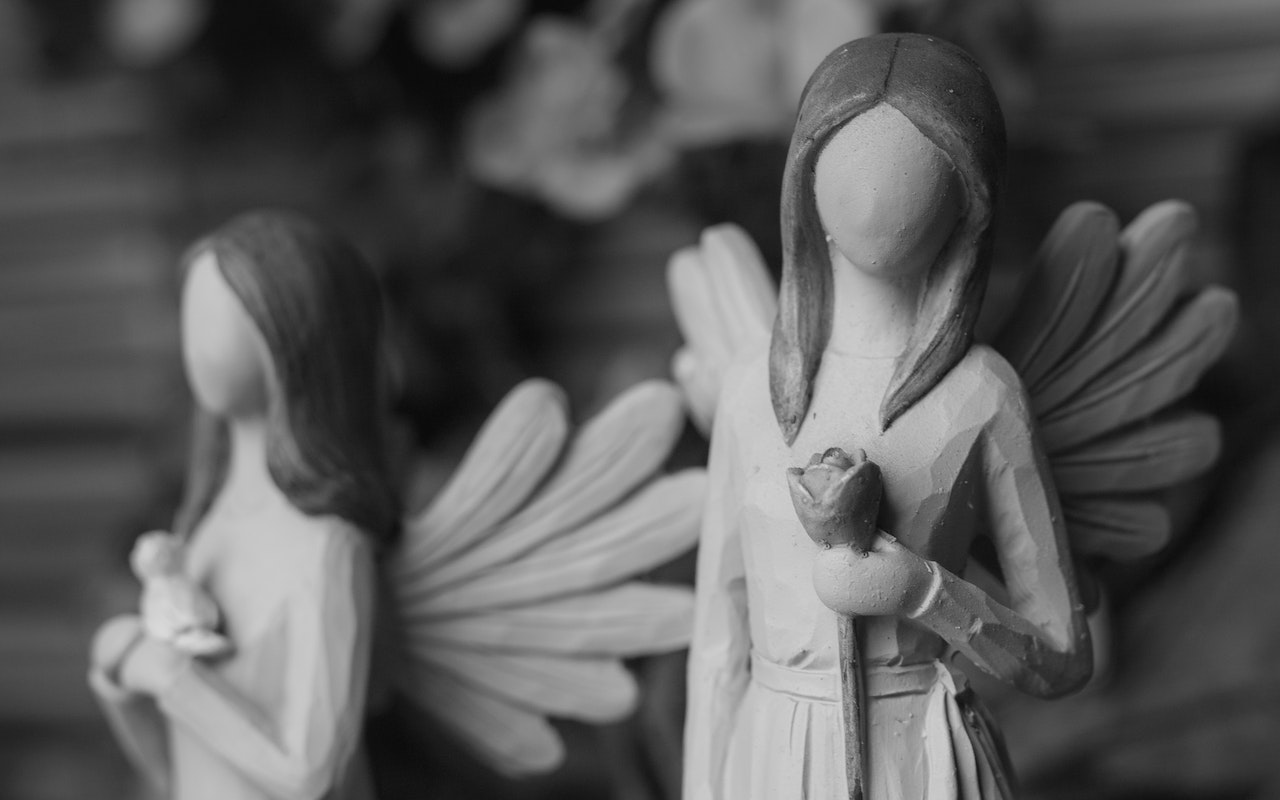 A Grayscale of Angel Figurines