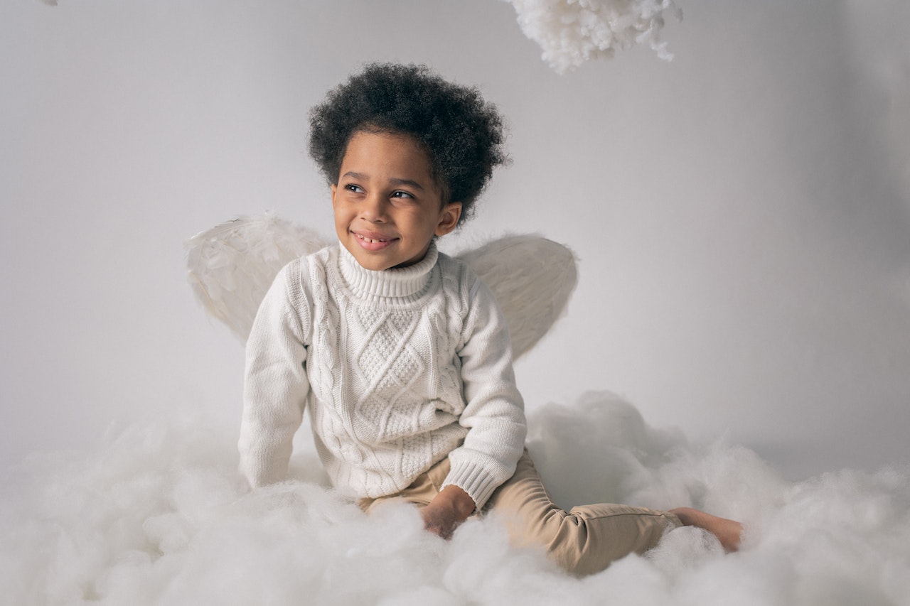 Happy Black Boy in Angel Costume on Cotton Wool