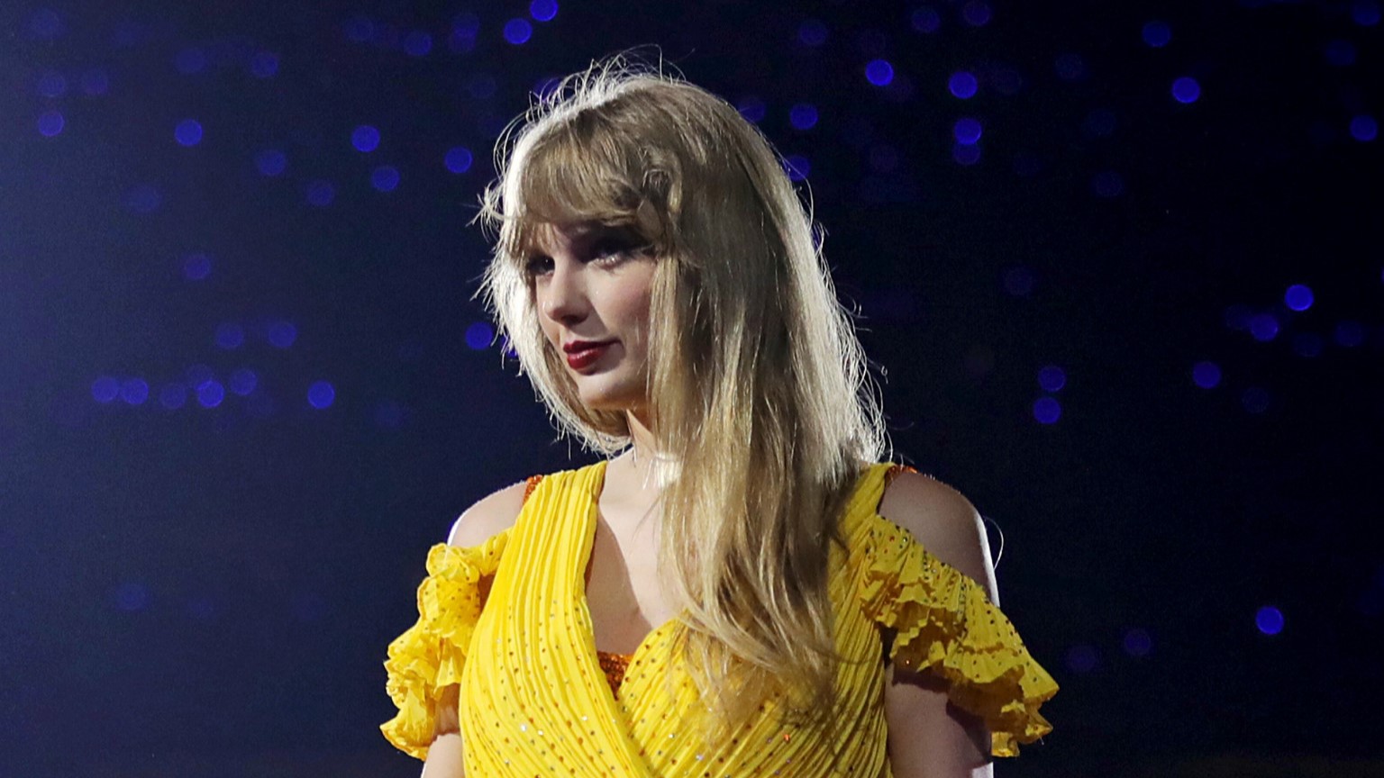 Taylor Swift wearing a yellow dress