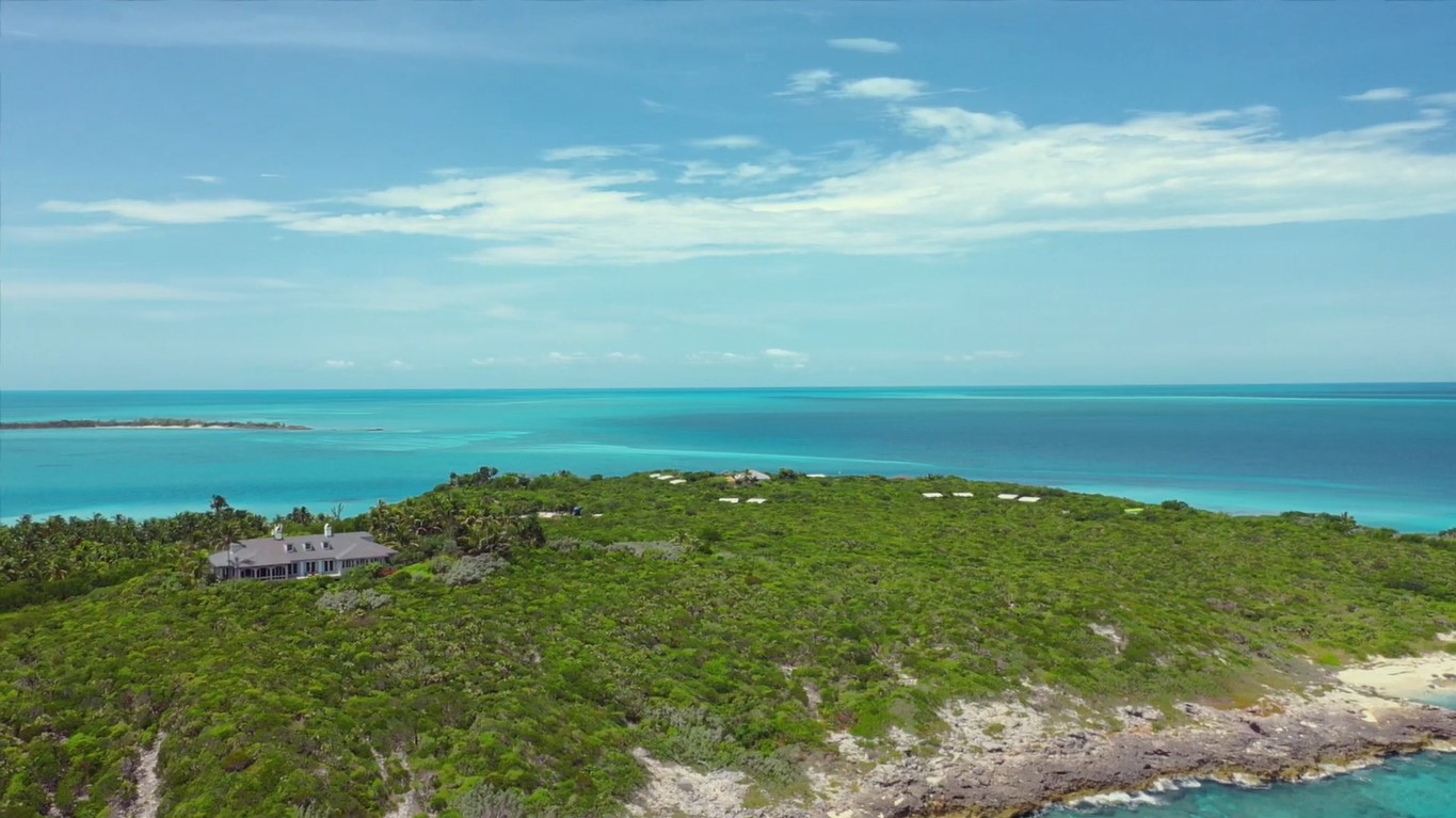 Aerial view of Musha Cay private island in the Bahamas, with a large house amidst the greenery