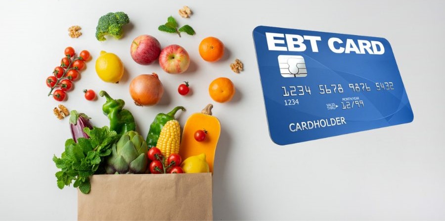 An ebt card placed beside a bag of grocery items