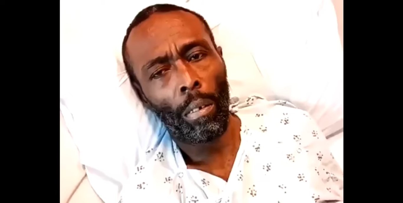 A sick and frail-looking Black Rob lying on a hospital bed