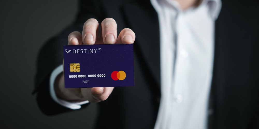 A man is showing Destiny credit card