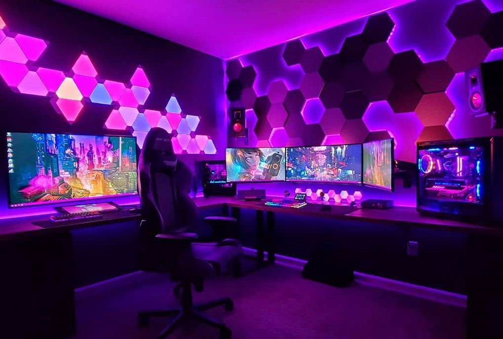 A high-end gaming PC and a curved ultrawide monitor are the centerpieces of an immersive and comfortable gaming experience, while ambient lighting sets the mood for captivating adventures.