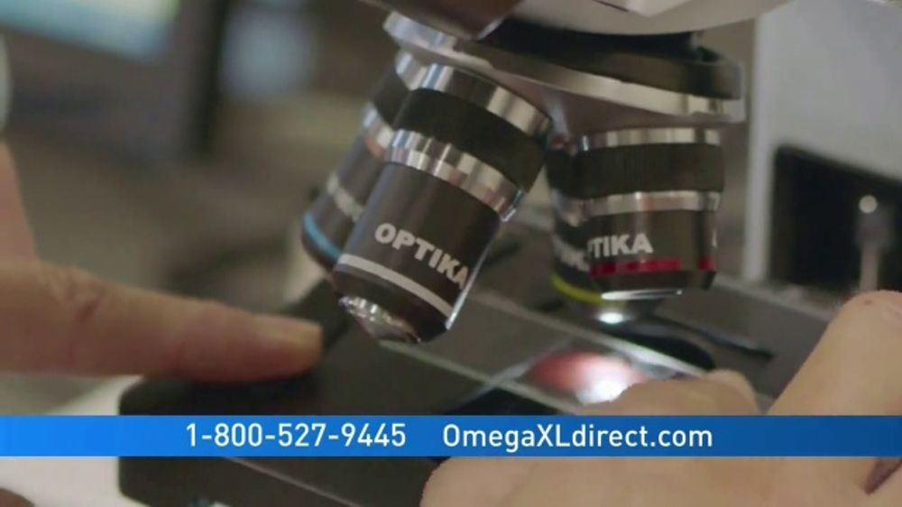 Close-up of a microscope with the brand name OPTIKA on the lenses, and it includes a phone number and a website, OmegaXLdirect.com, suggesting it is from an advertisement or informational material for OmegaXL.