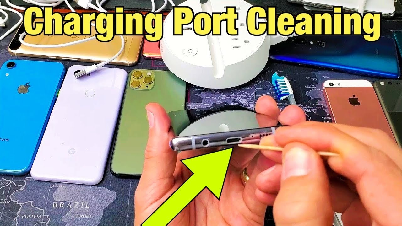 A hand uses a tool to clean the charging port of a smartphone, surrounded by various devices, with the text "Charging Port Cleaning" overhead.