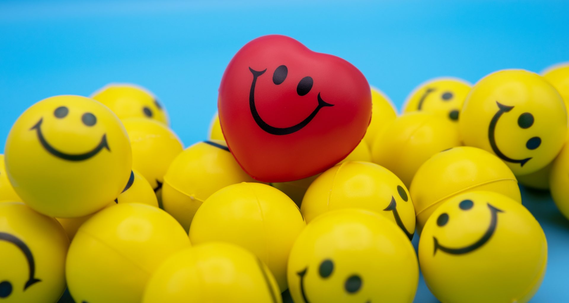 A red smile emoji is present on yellow smile emojies.