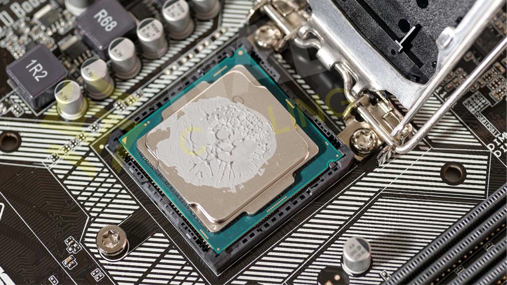 Central processing unit (CPU) on a motherboard with an excessive amount of thermal paste applied, highlighting the importance of using the correct quantity for efficient heat transfer.