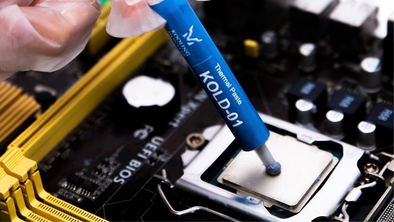 A precise application of thermal paste being applied onto a CPU from a syringe, suggesting a step in preparing a computer processor for heat sink installation.