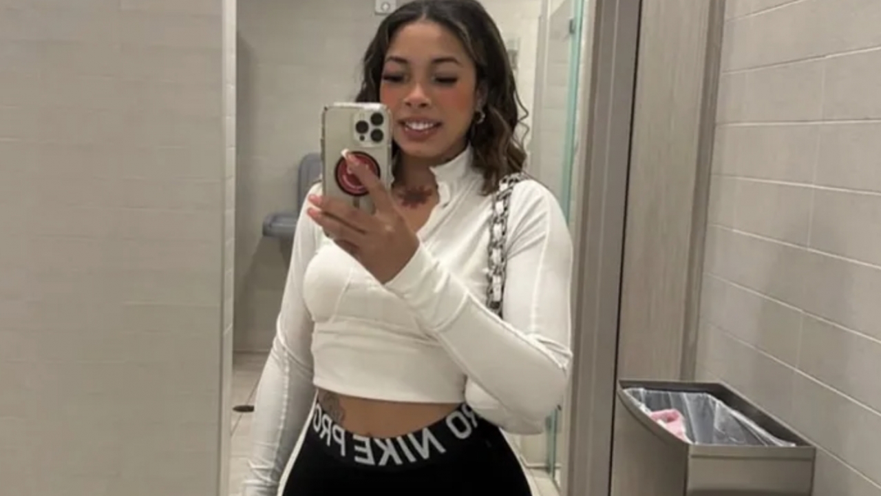 Marayna Rodgers taking a snap with her phone while standing before a mirror