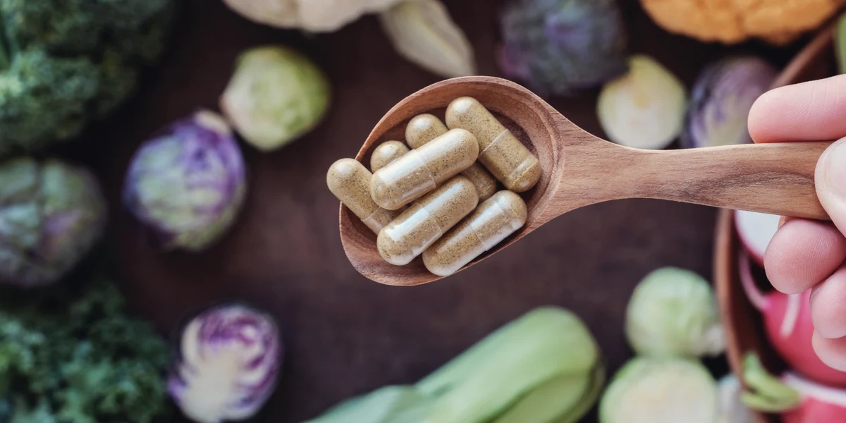 Fiber supplement capsules in a wooden spoon
