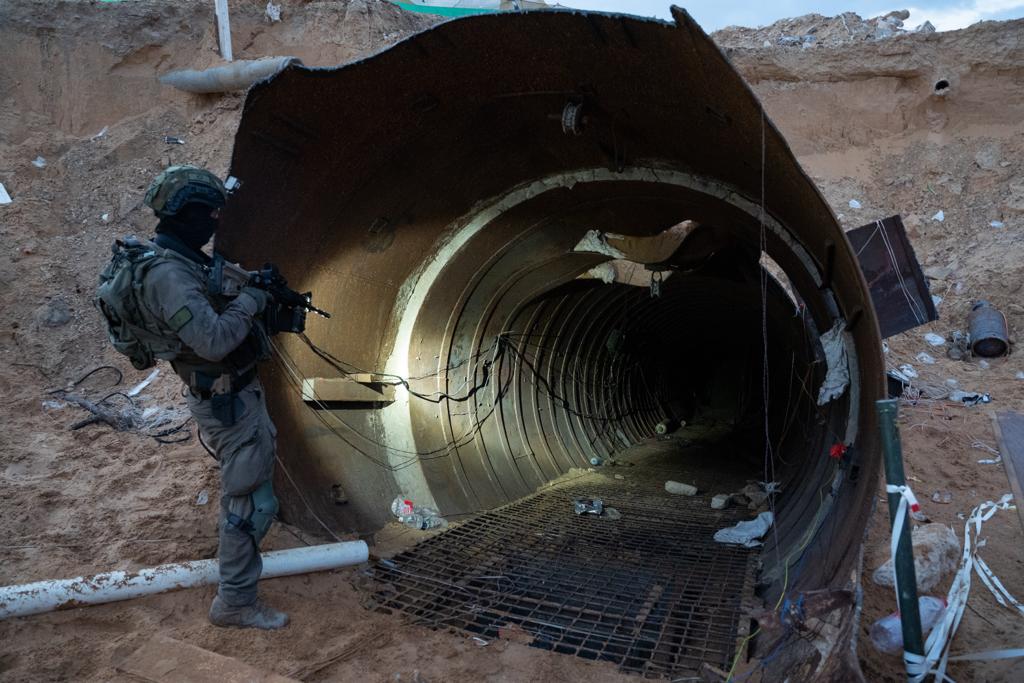 A soldier stands at the entrance to a large Hamas tunnel found near the Erez border crossing in the northern Gaza Strip, in a handout image published December 17, 2023