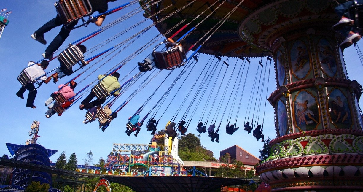 People are riding a Disneyland swing