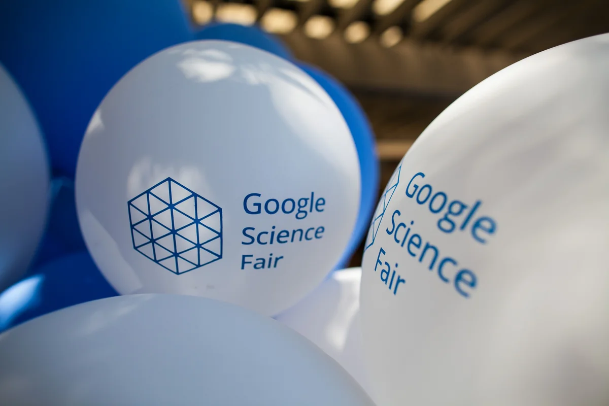 Close-up shots of balloons branded with the "Google Science Fair" logo.