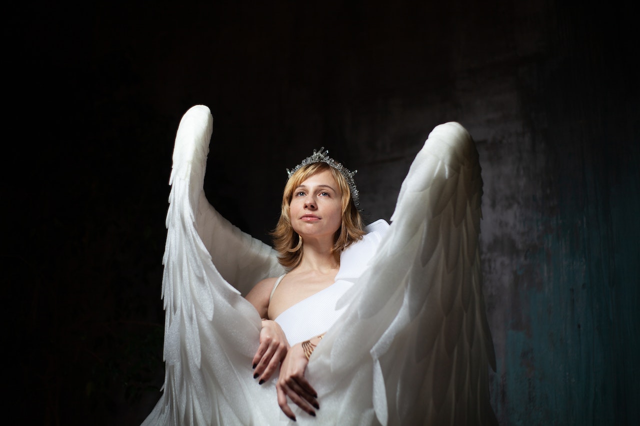 Gentle Model With Angel Wings on Dark Background