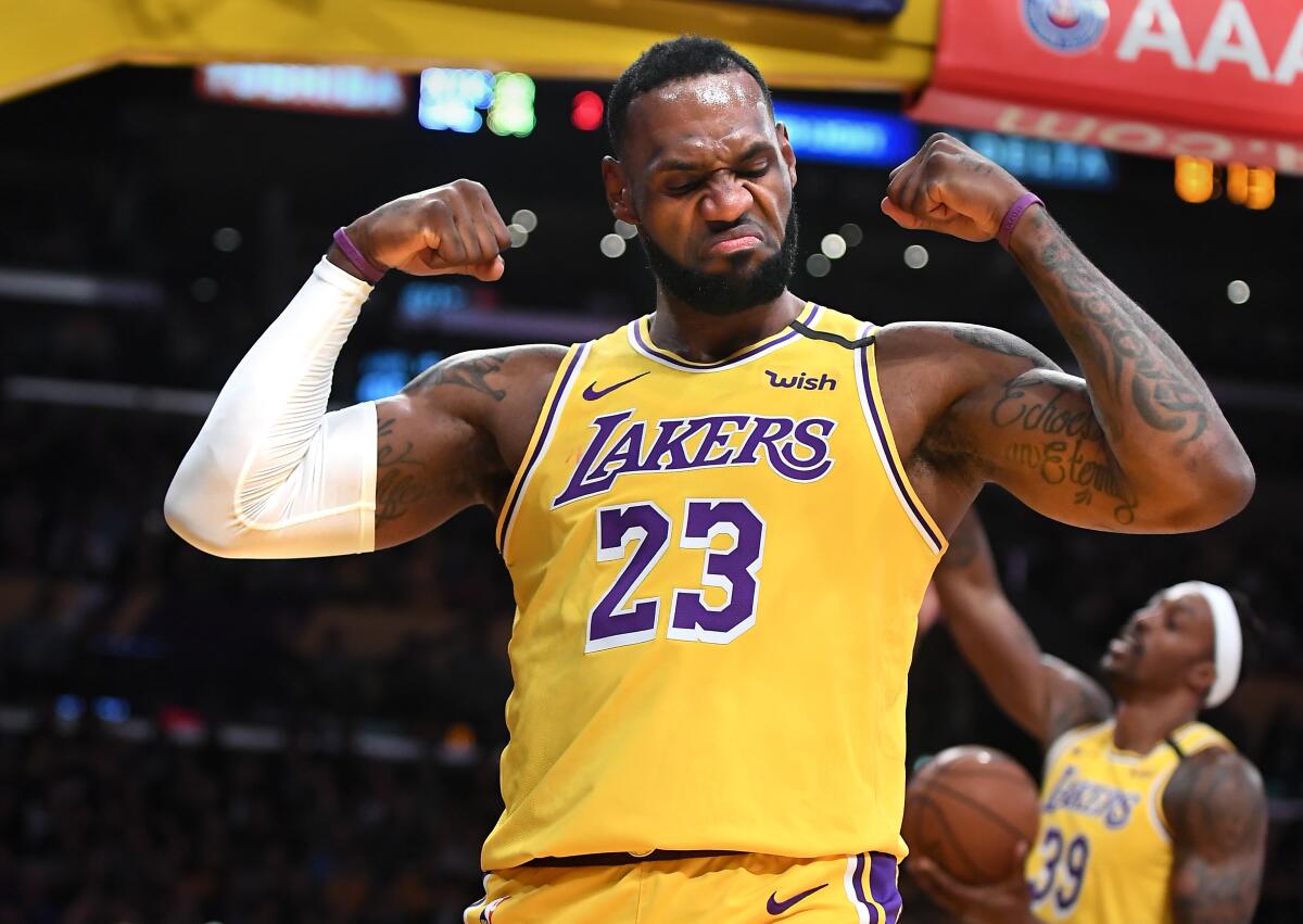 LeBron James wearing a yellow Los Angeles Leakers jersey