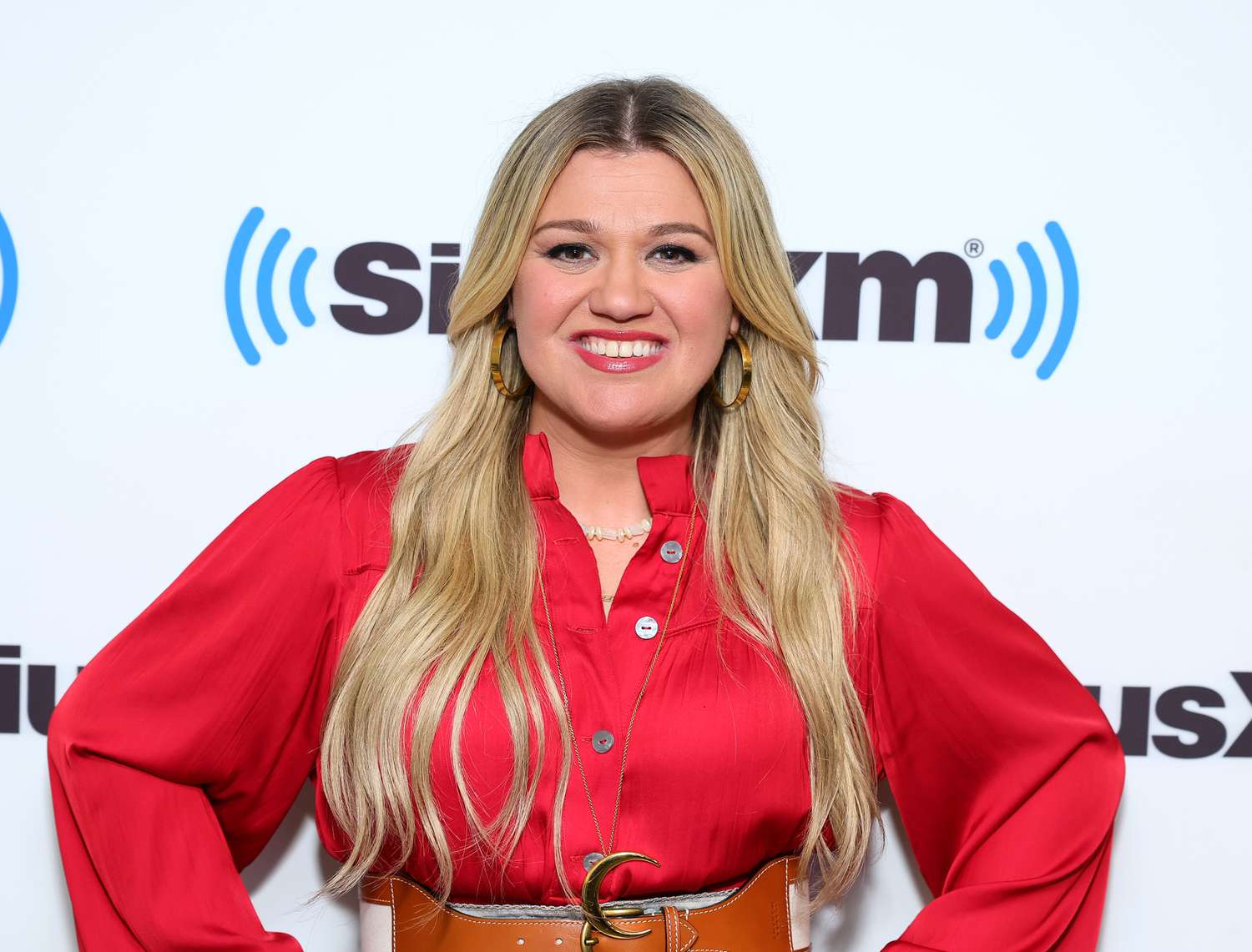 Kelly Clarkson wearing a red polo long sleeves