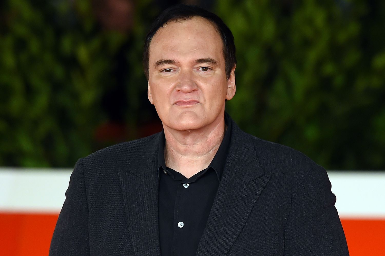 Quentin Tarantino wearing a black coat