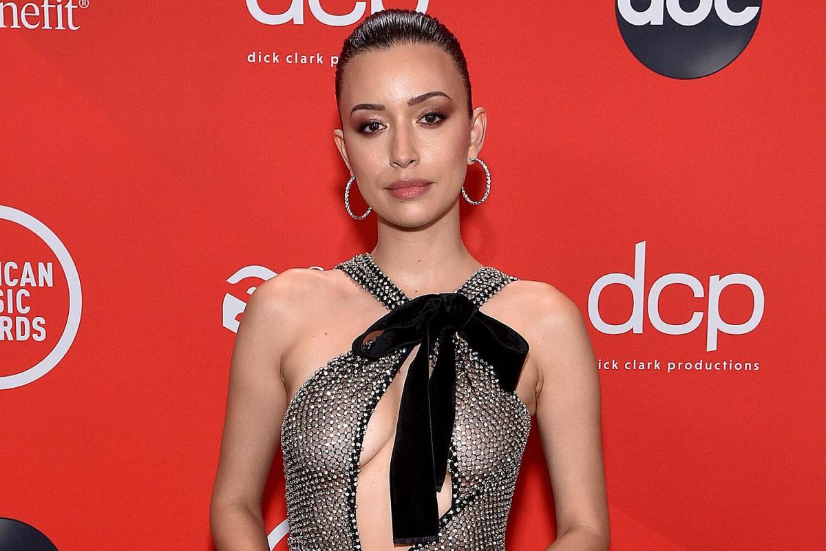Christian Serratos wearing a silver gown at an event