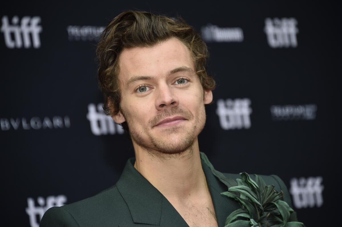 Harry Styles wearing a green suit