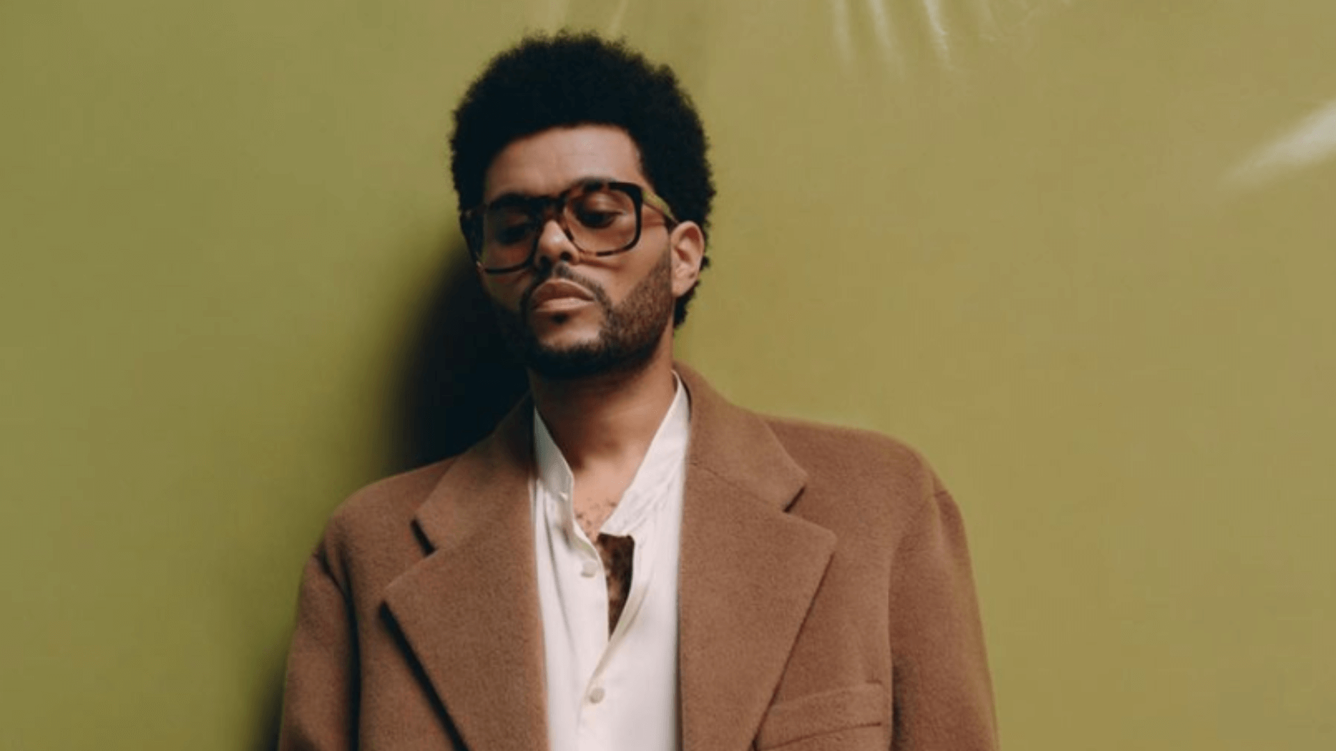 The Weeknd wearing a brown trenchcoat