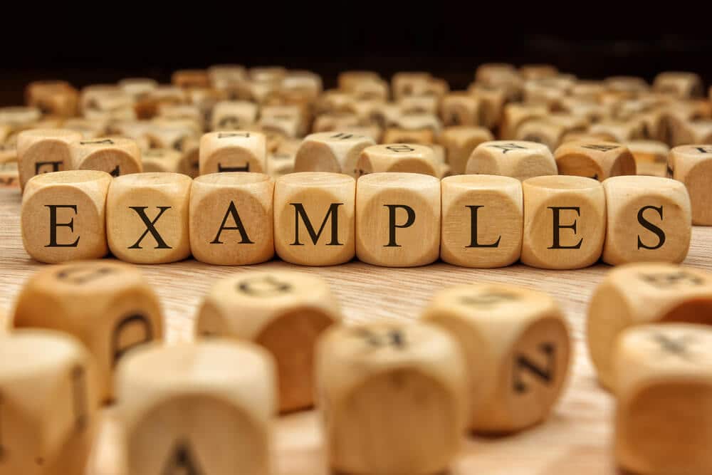 A stack of wooden cubes with the word "EXAMPLES" written on them.