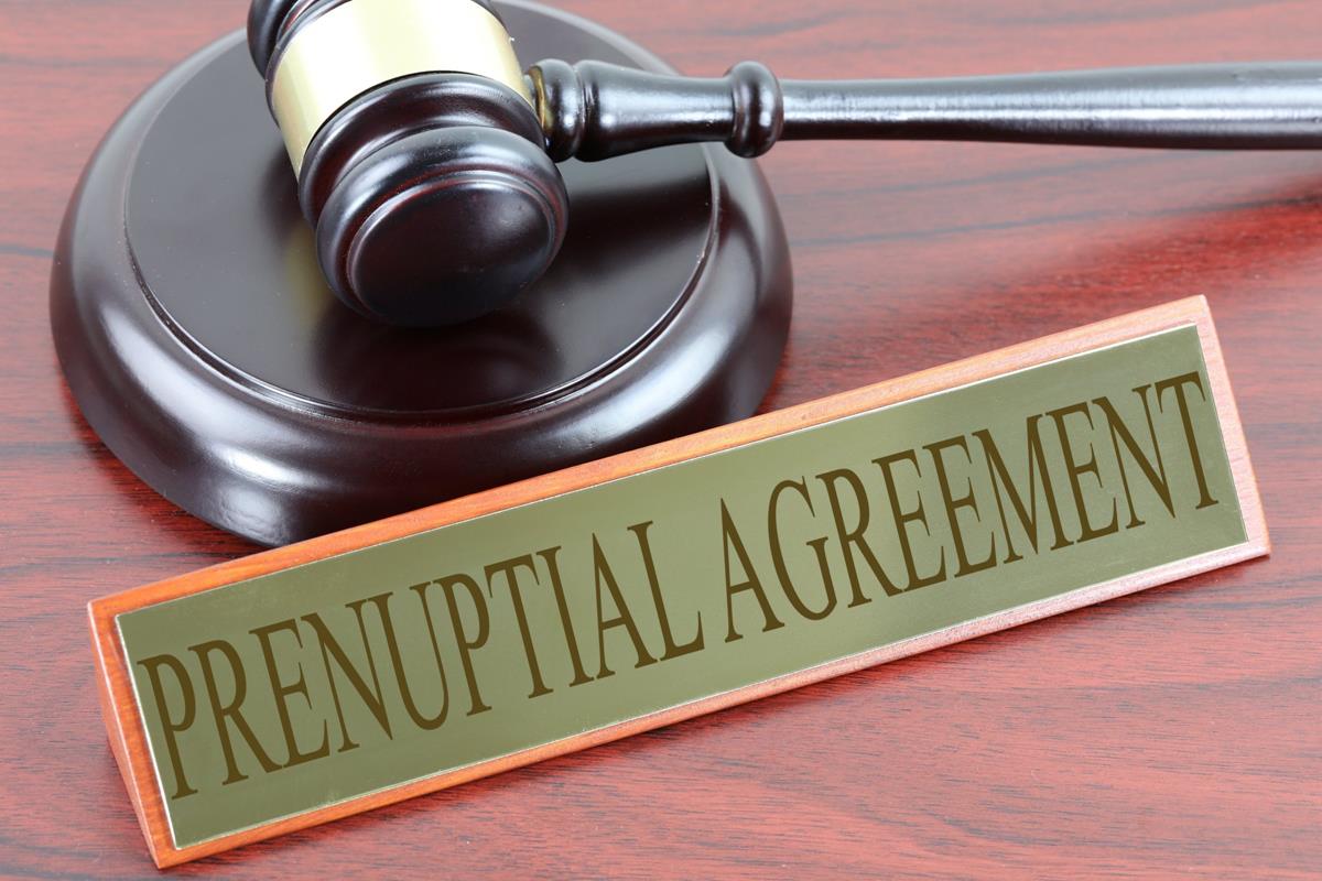 Prenuptial agreement sign and a brown gavel