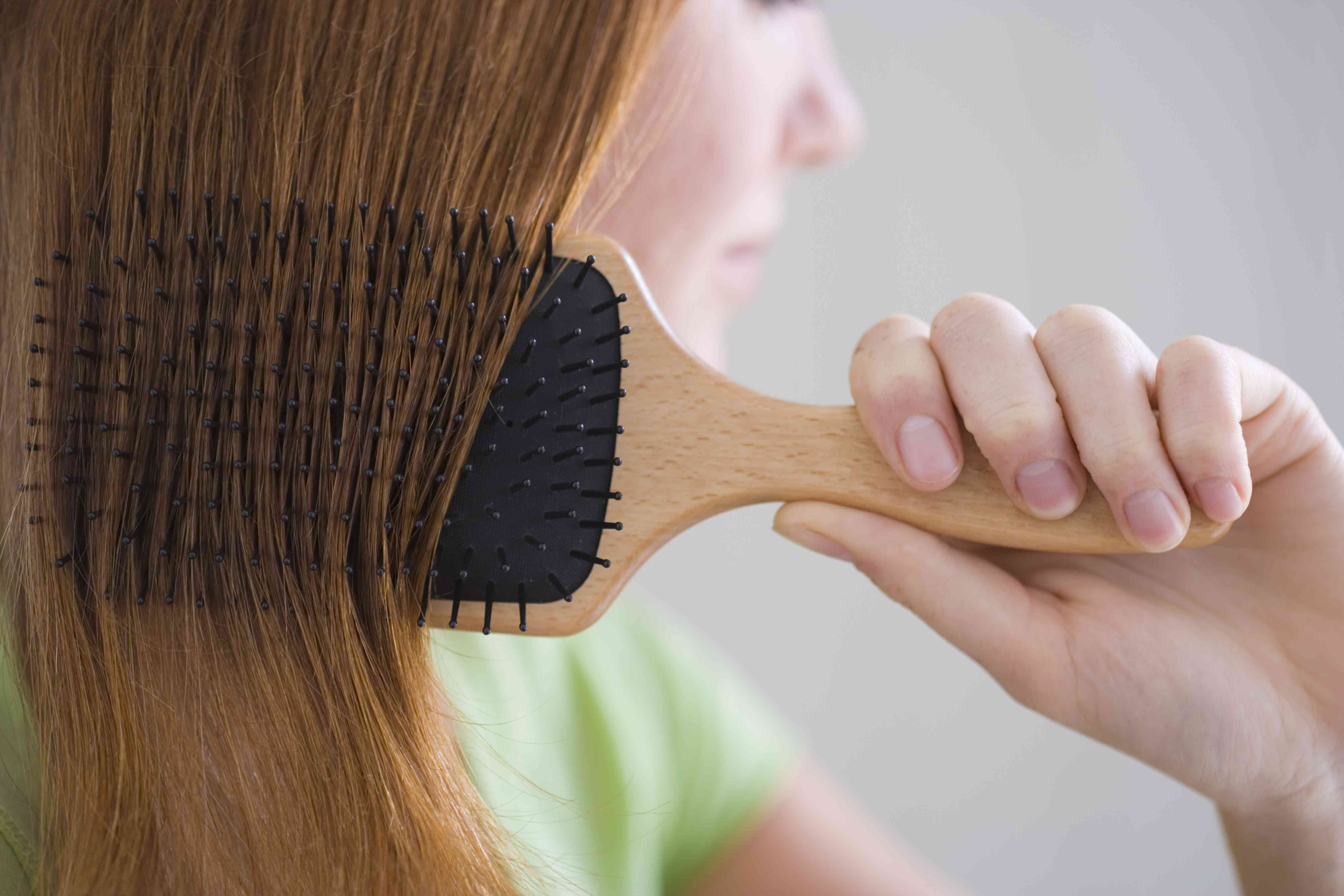 A girl combing her hair.