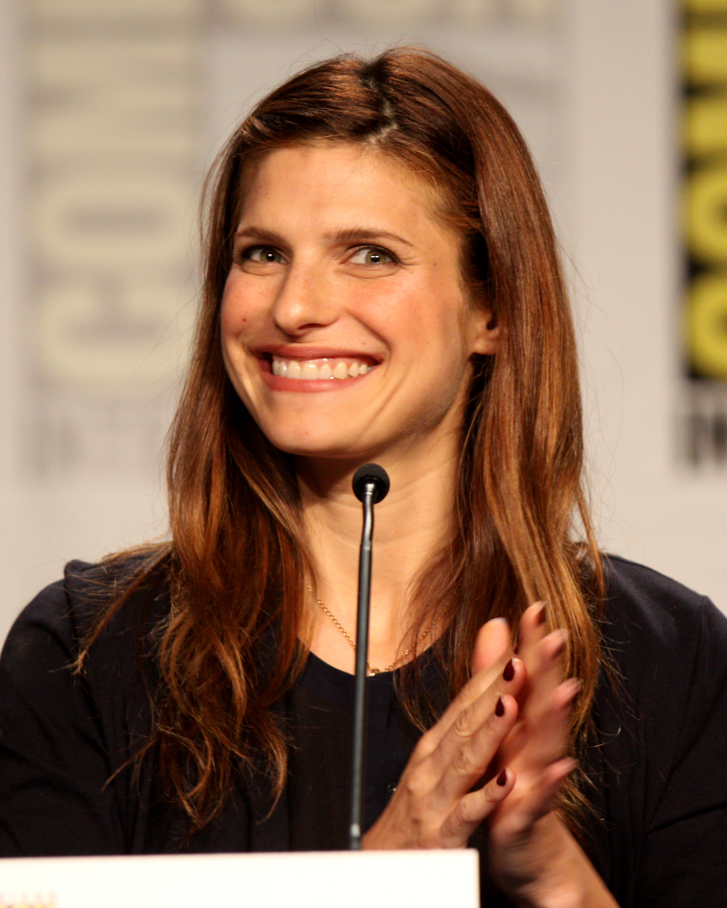 Lake Bell Wearing A Black Blouse With A Wireless Mic In Front