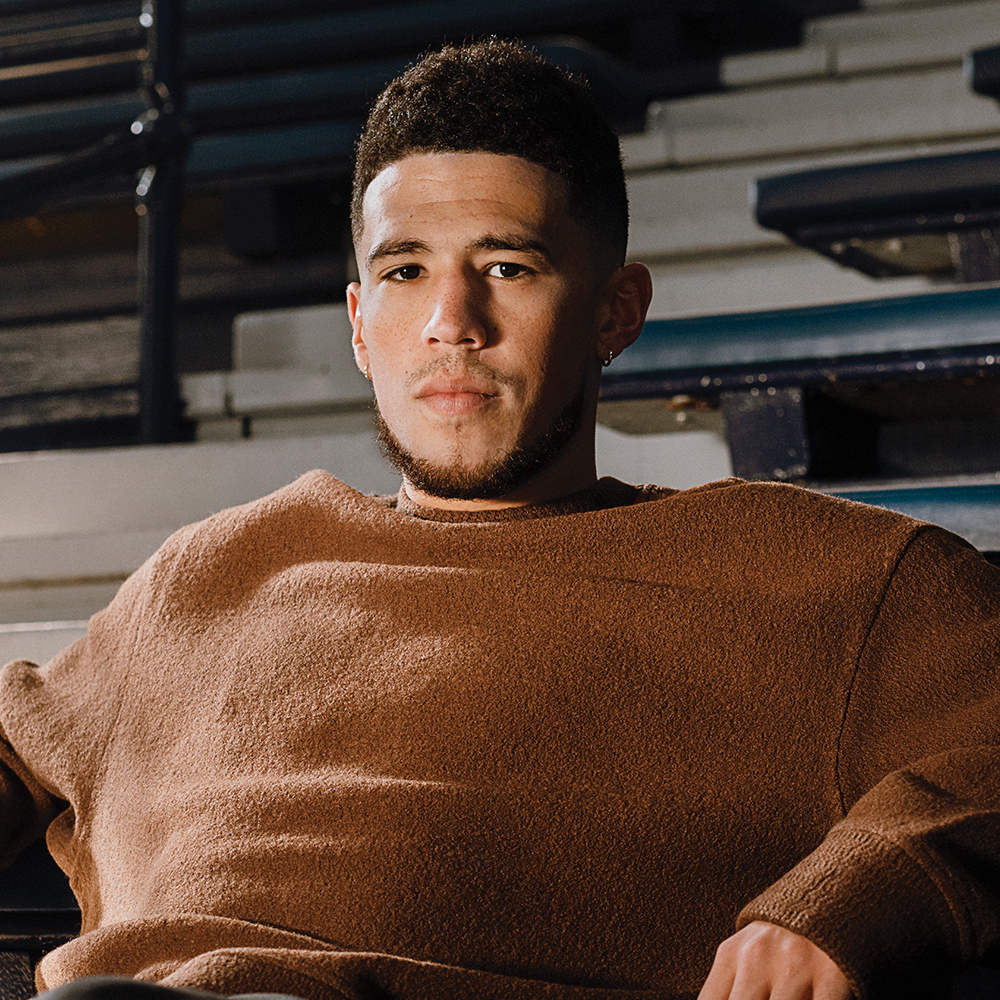Devin Booker wearing a brown blouse