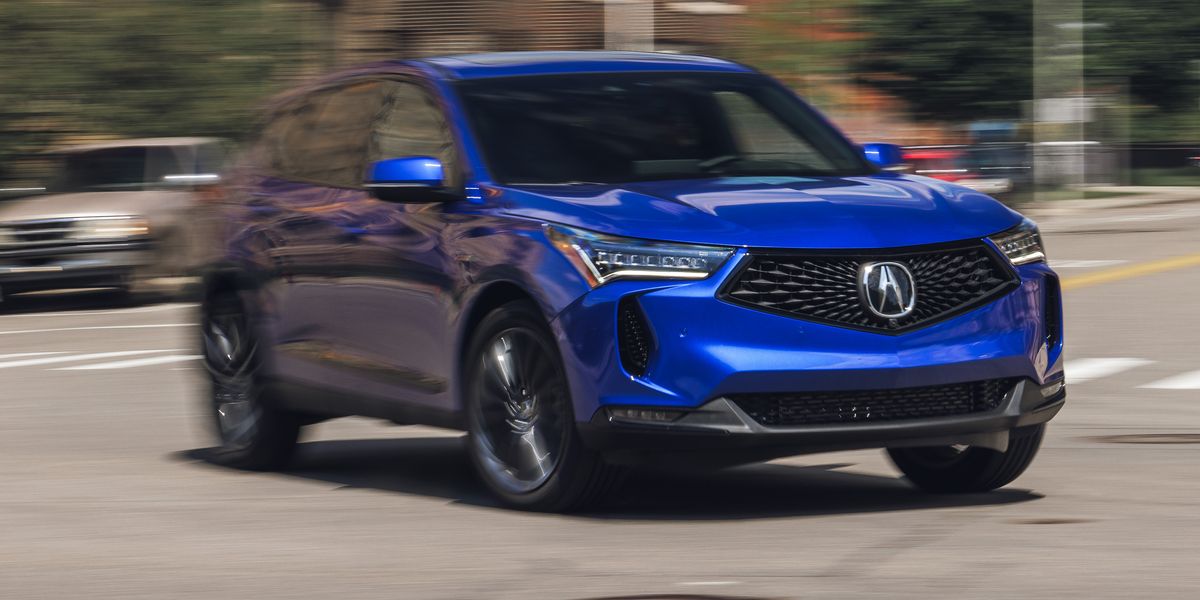 Blue 2023 Acura RDX driving on road