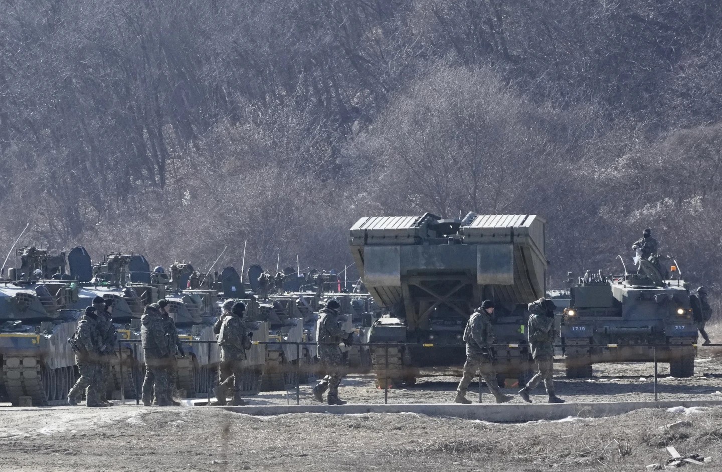 North Korea soldiers pass in front of their tanks