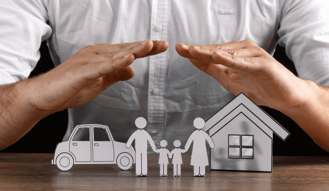 A person using two hands to shield a family, a car, and a house