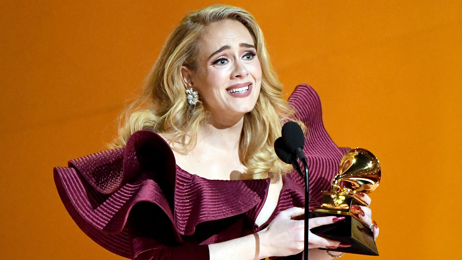 Adele winning a trophy