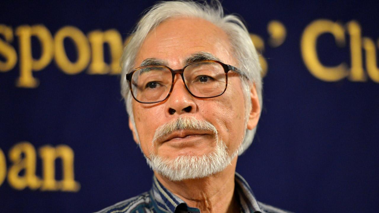 Hayao Miyazaki wearing a blue stripe poloo