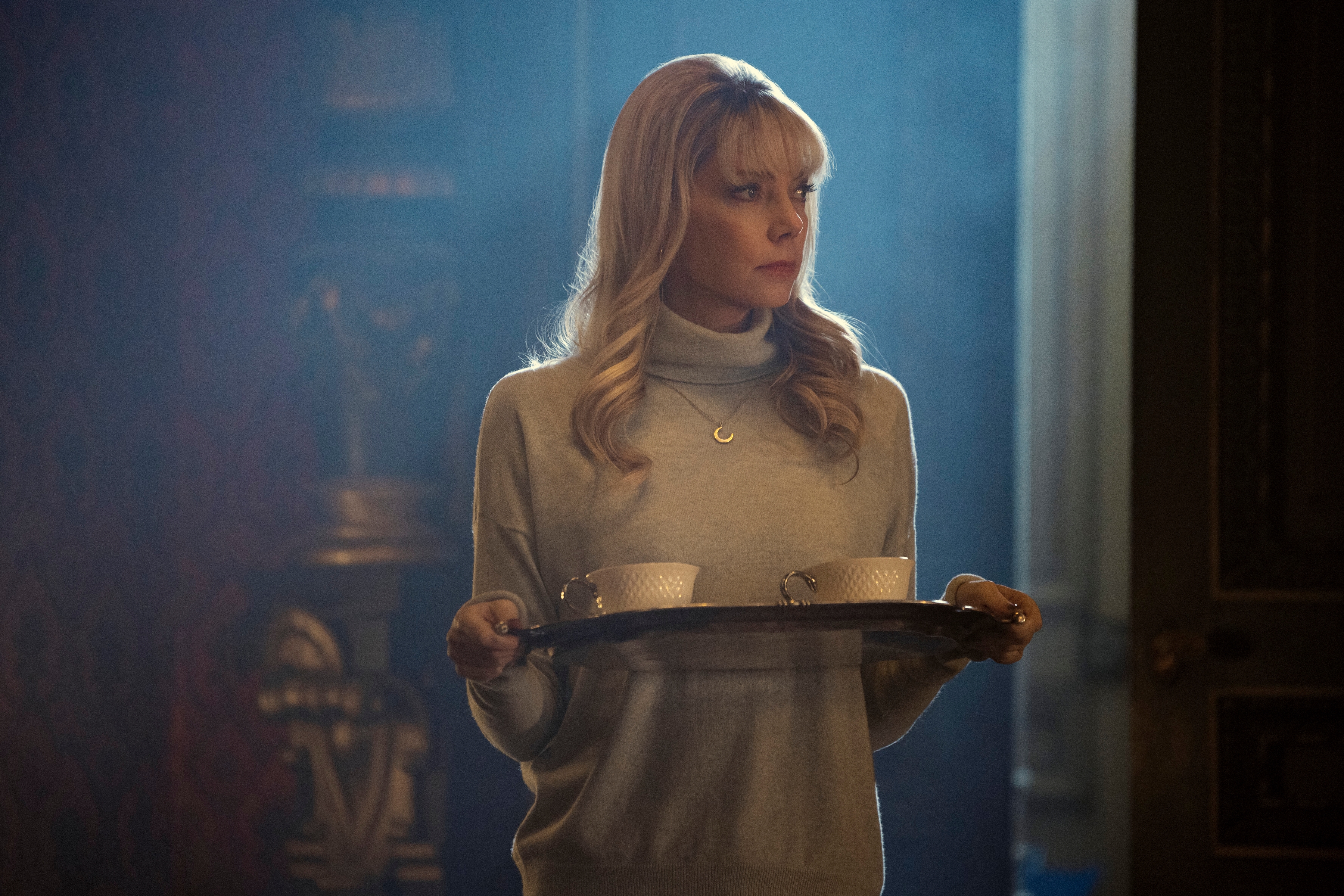Riki Lindhome holding a tea serving tray