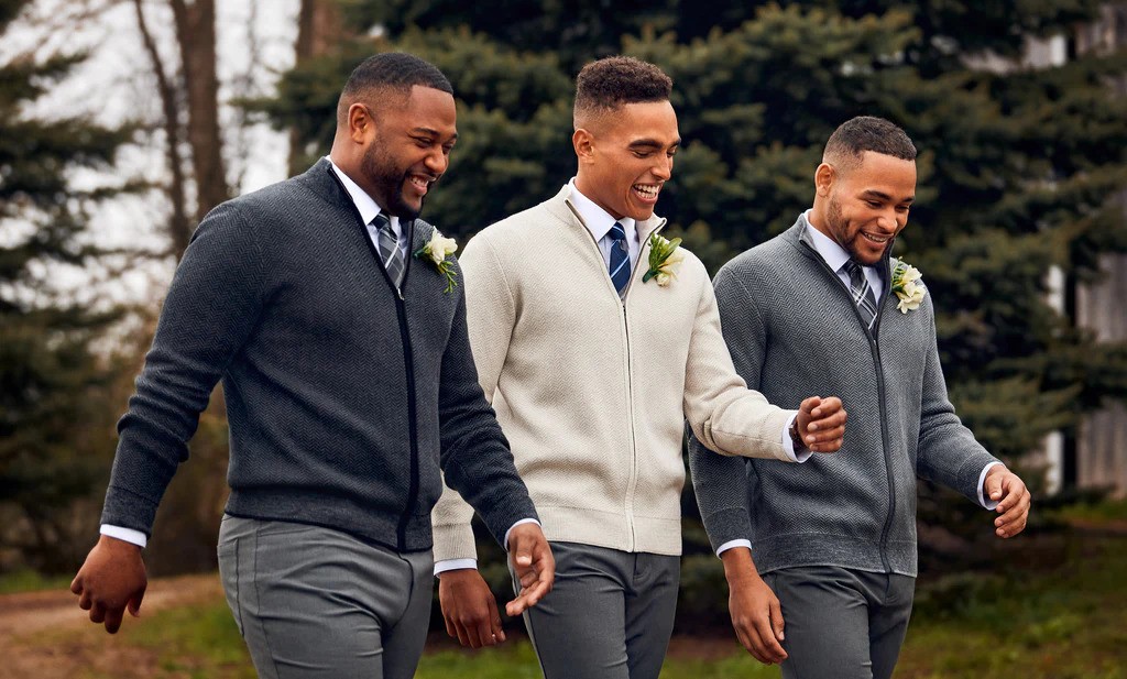 Three men dressed in cardigan and pants