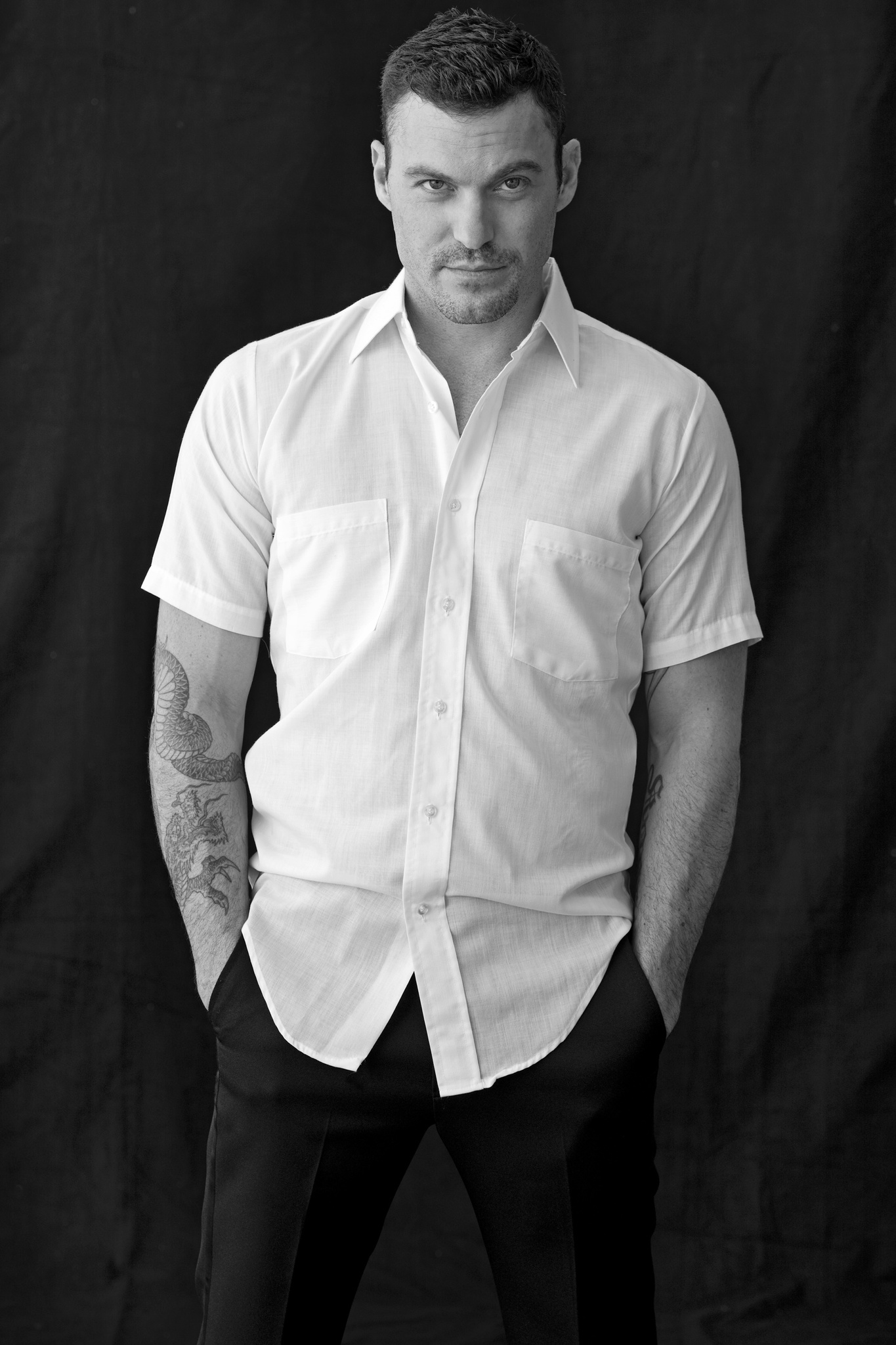 Brian Austin wearing a black trouser and white shirt