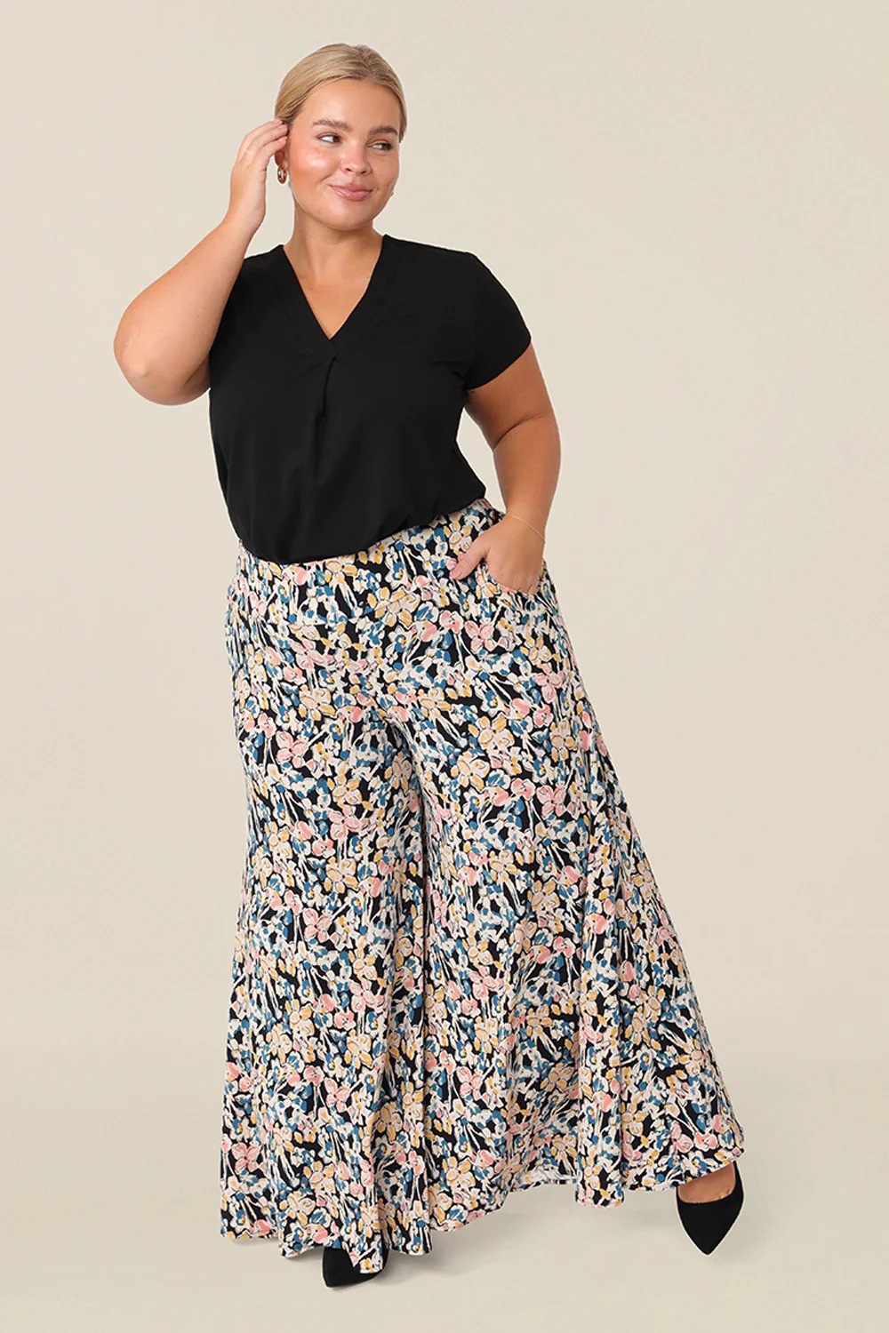 A woman wearing a wide-leg pant on a black top