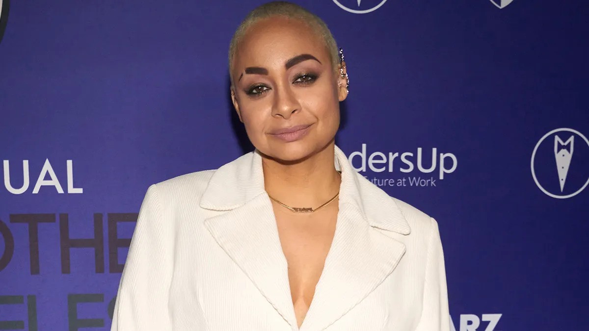 Raven Symone wearing a white jacket at an event