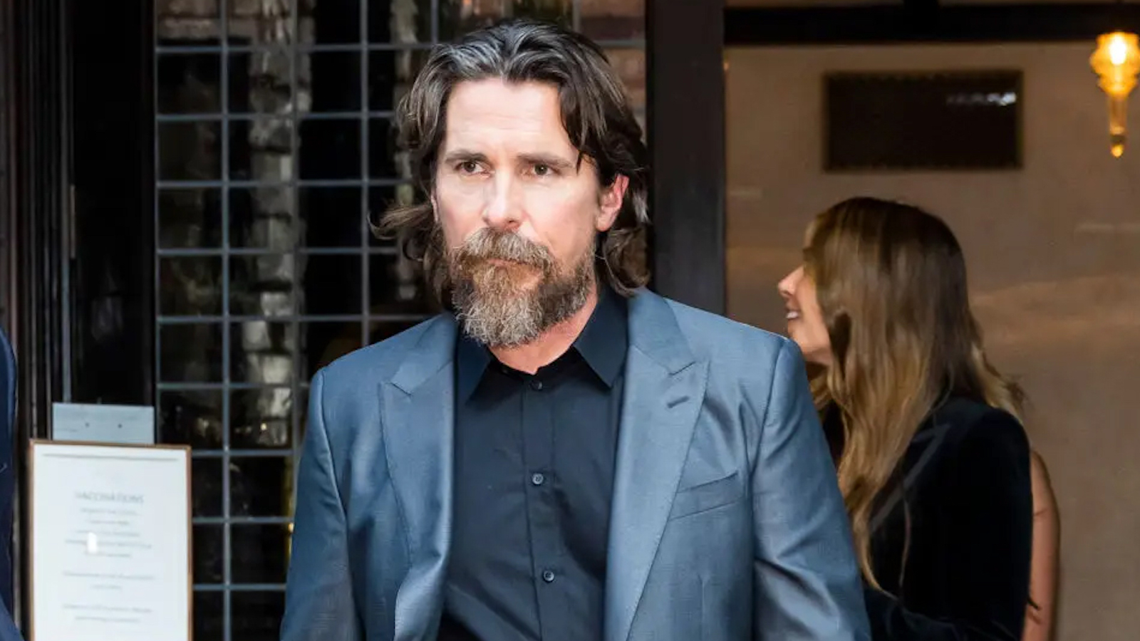 Christian Bale wearing a gray coat