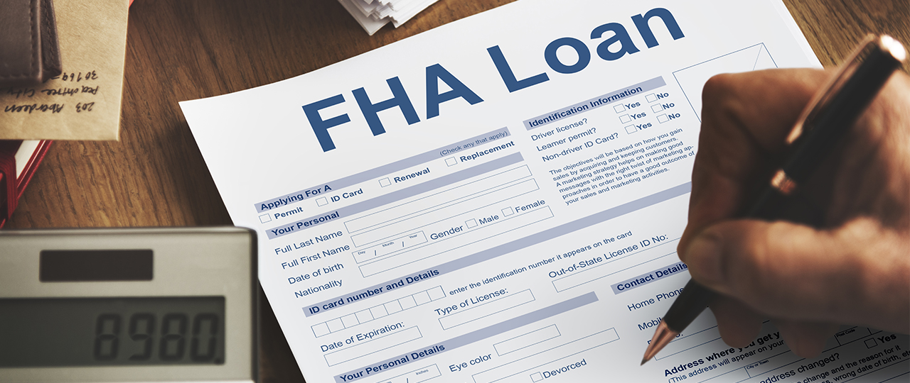 A person is filling FHA Loan form with pencil.