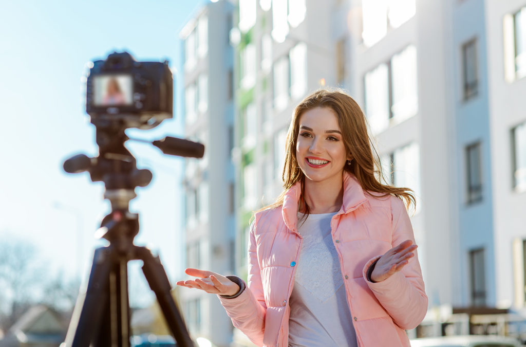 A woman recording in front of a camera