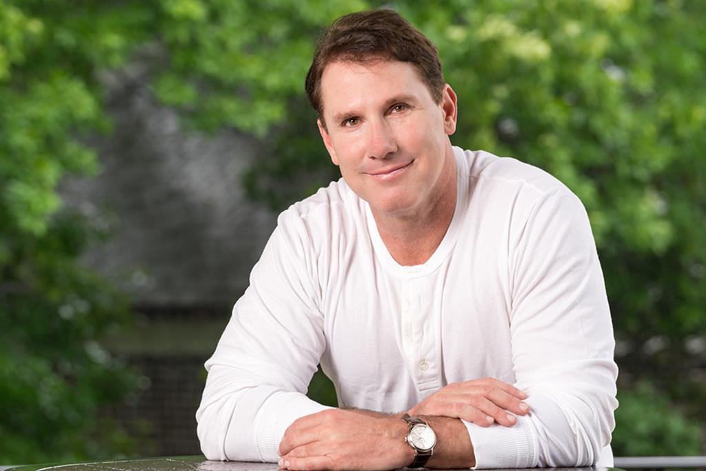 Nicholas Sparks wearing a white sweater