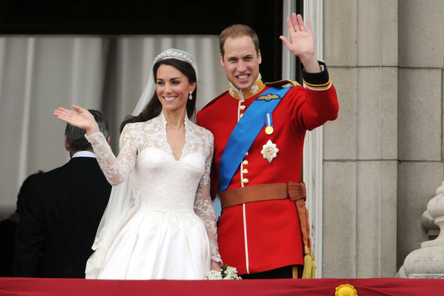 Kate Middleton wearing a white wedding gown and Prince William wearing a red wedding outfit