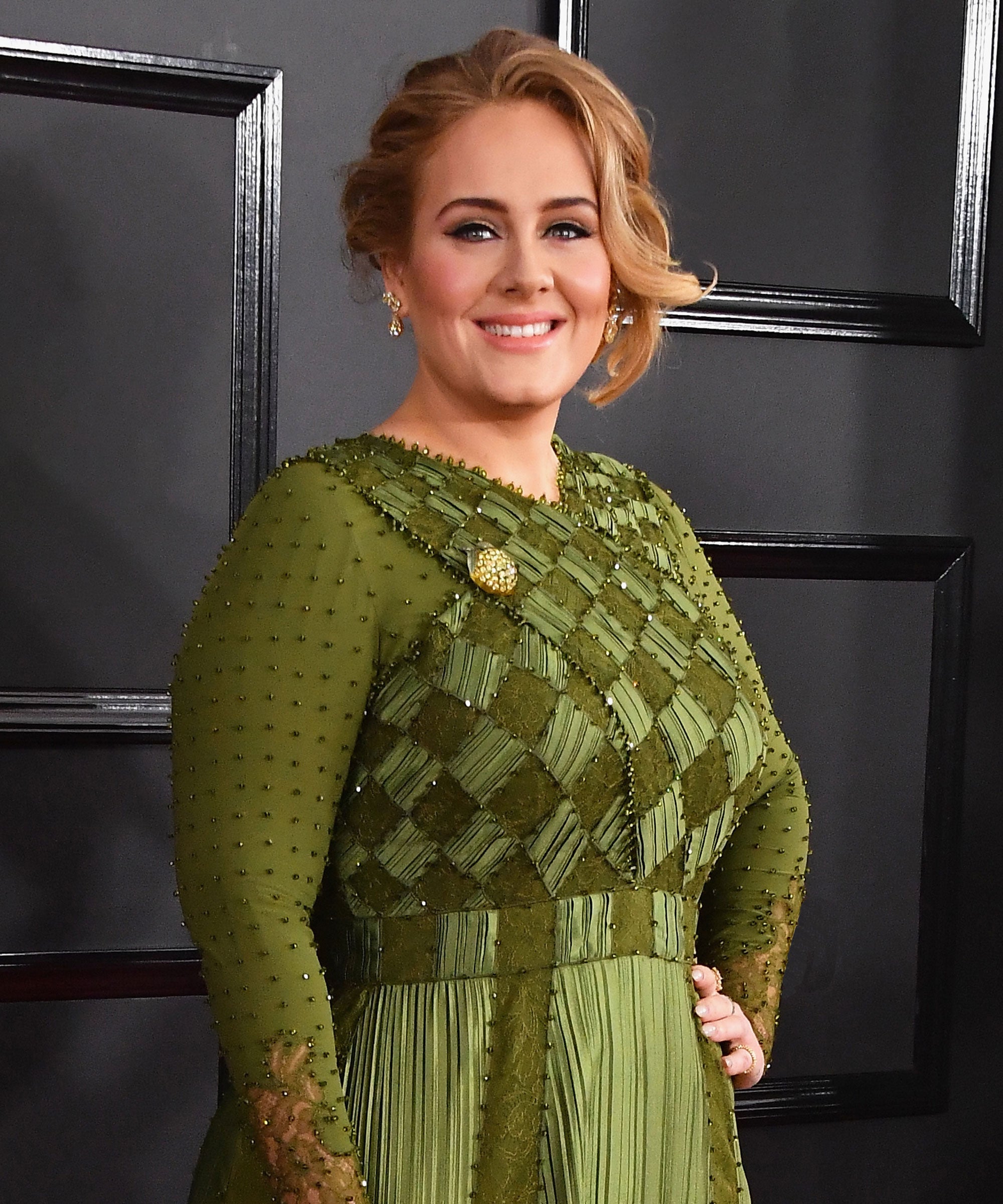 Adele wearing a green dress