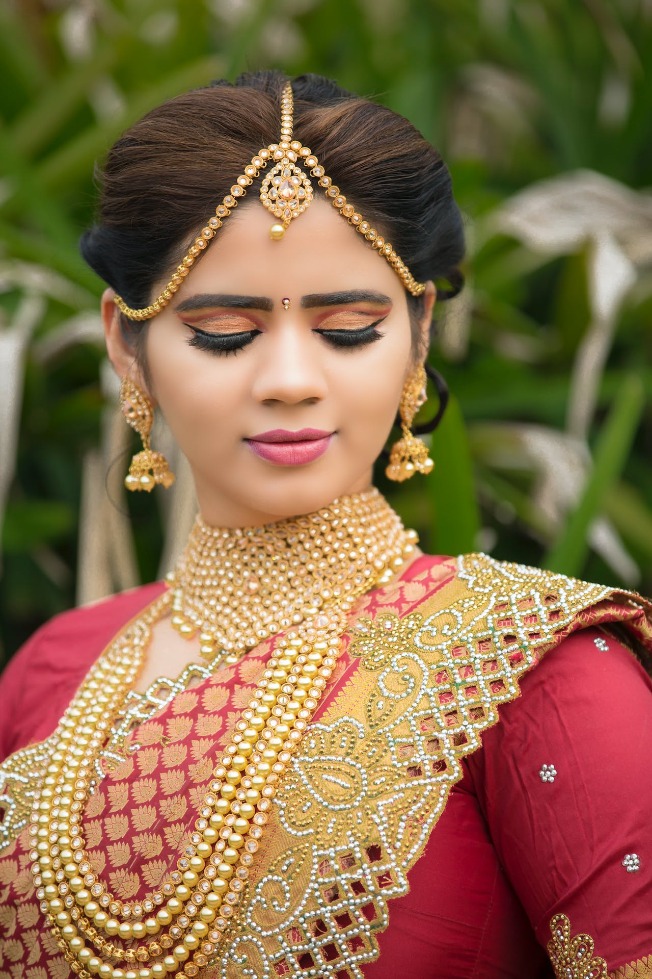 An Indian woman wearing gold jewelry.