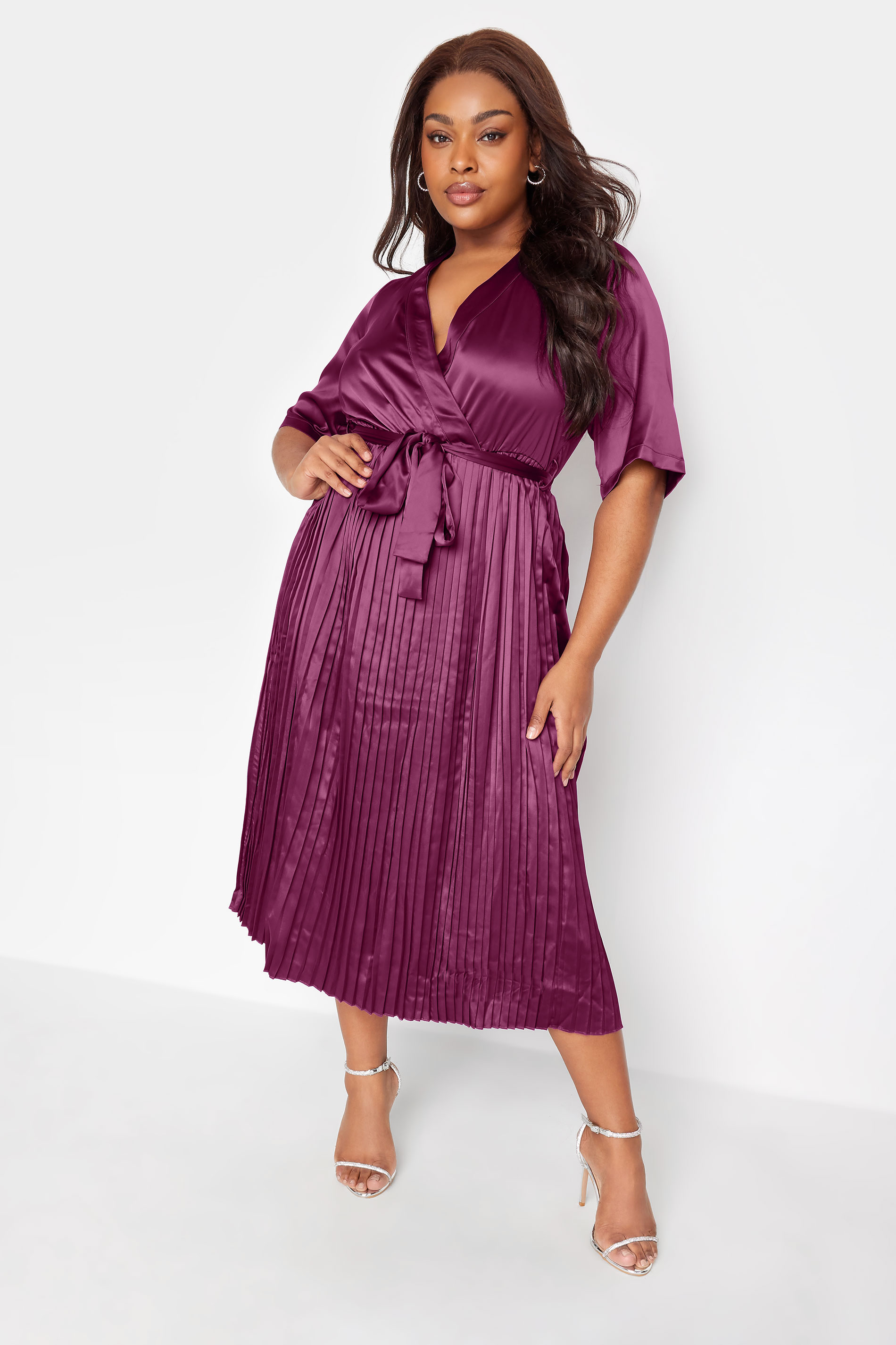 A woman wearing YOURS LONDON Curve Purple Satin Pleated Wrap Dress